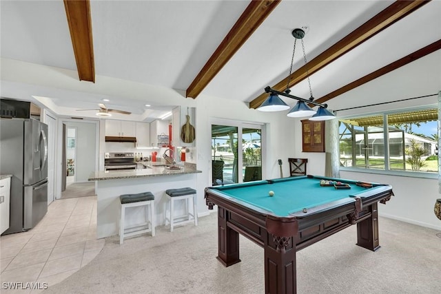 recreation room with lofted ceiling with beams, light tile patterned floors, light carpet, and a sink