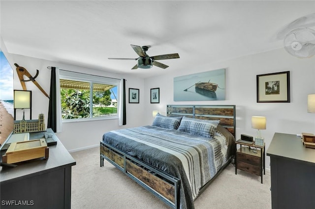 bedroom with baseboards, a ceiling fan, and light colored carpet