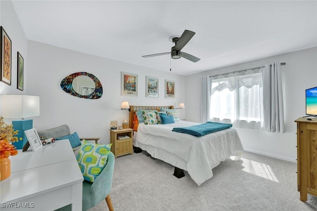 bedroom featuring light carpet, ceiling fan, and baseboards