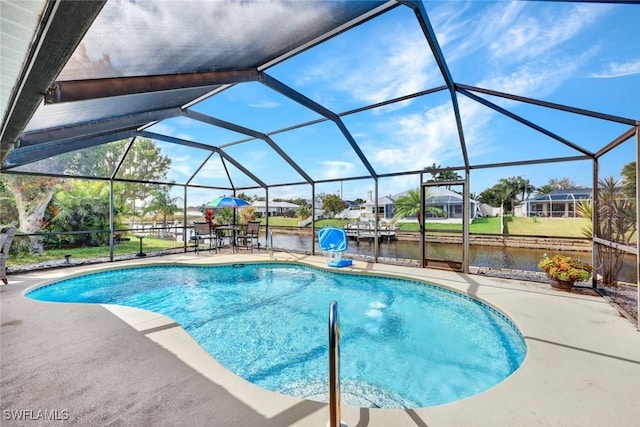 outdoor pool featuring a water view, a patio area, and glass enclosure