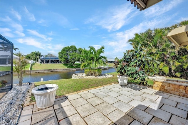 view of patio / terrace with a lanai and a water view