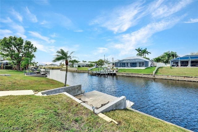 view of dock with a yard, a water view, and a residential view