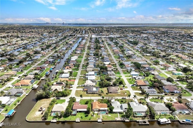 drone / aerial view with a water view and a residential view