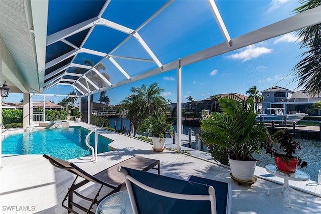 view of swimming pool with a water view, glass enclosure, a pool with connected hot tub, and a patio