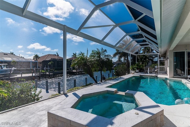 view of swimming pool with a lanai, a pool with connected hot tub, and a patio