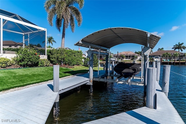 dock area with glass enclosure, a water view, a lawn, and boat lift