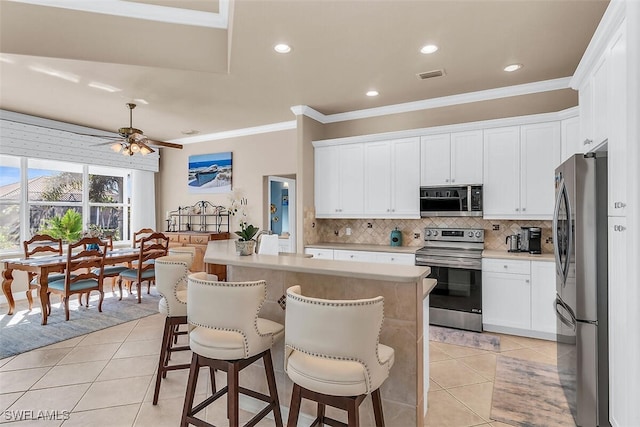 kitchen with appliances with stainless steel finishes, visible vents, decorative backsplash, and light tile patterned floors