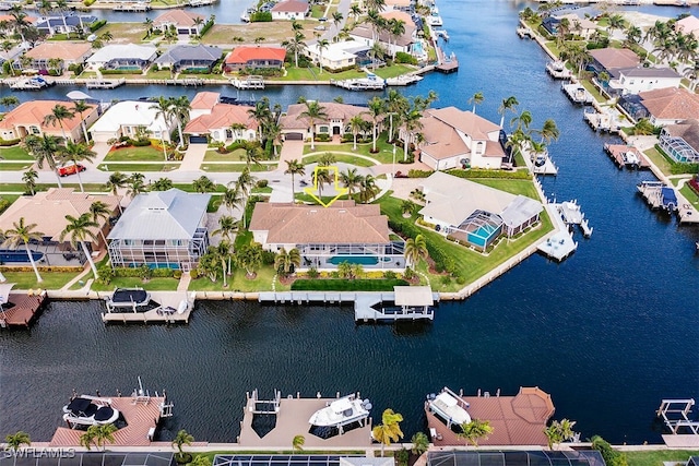 birds eye view of property with a water view and a residential view