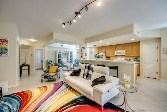 living room with recessed lighting, baseboards, and light tile patterned floors