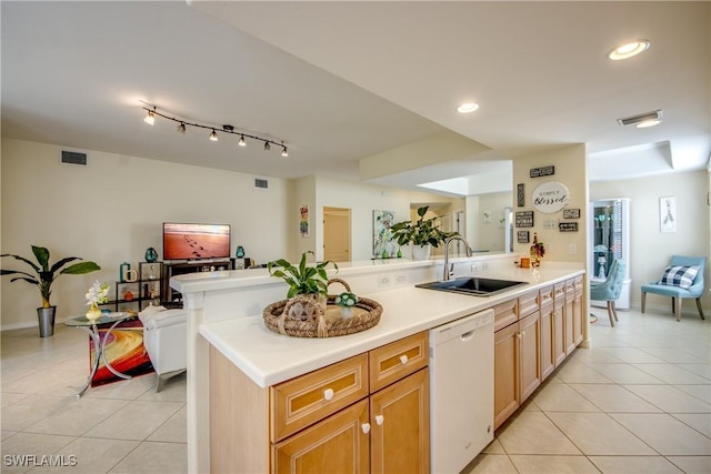 kitchen with dishwasher, light tile patterned floors, a sink, and visible vents