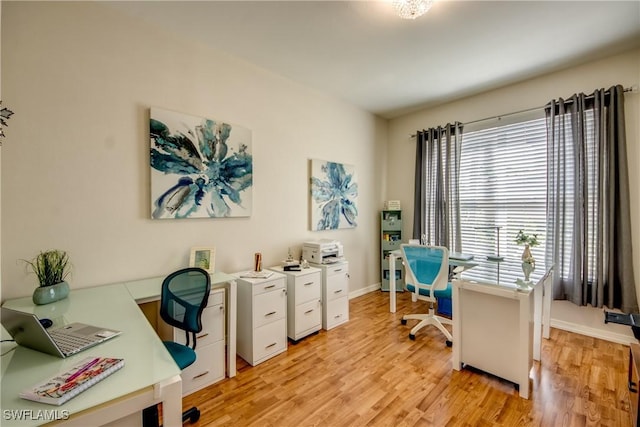 home office with light wood-style floors and baseboards