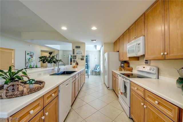 kitchen featuring light tile patterned flooring, recessed lighting, white appliances, a sink, and light countertops