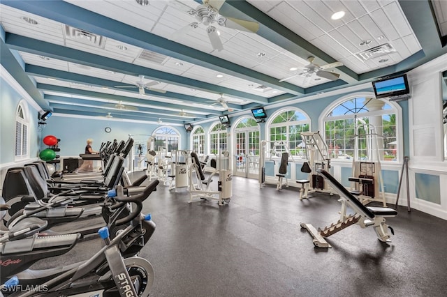 workout area featuring baseboards and a ceiling fan