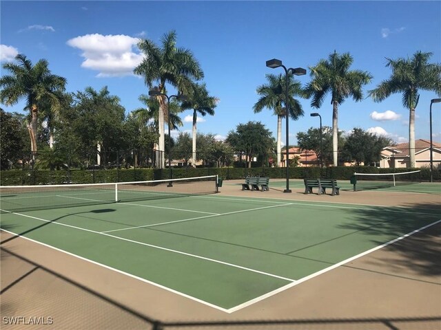 view of tennis court with fence