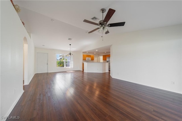 unfurnished living room with ceiling fan, dark wood-style flooring, arched walkways, and visible vents