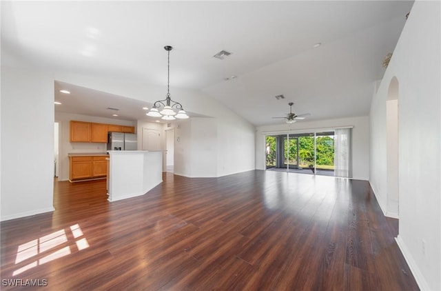 unfurnished living room with dark wood-style floors, lofted ceiling, visible vents, and baseboards