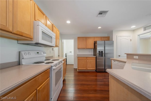 kitchen featuring washer / dryer, light countertops, white appliances, and visible vents