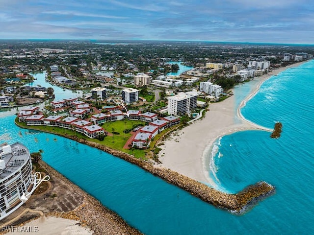 aerial view featuring a view of city, a water view, and a beach view