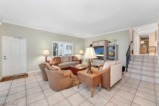 living room with light tile patterned flooring, crown molding, baseboards, and stairs