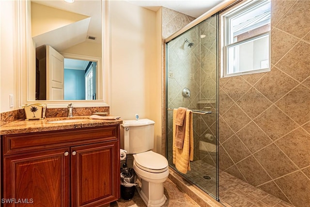 bathroom featuring a stall shower, vanity, and toilet