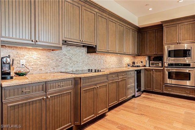 kitchen featuring decorative backsplash, wine cooler, appliances with stainless steel finishes, ventilation hood, and light wood-style floors