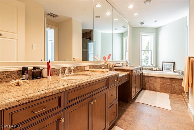 full bathroom featuring visible vents, vanity, a bath, and tile patterned floors