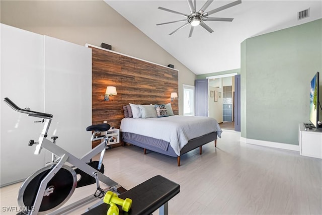 bedroom with visible vents, baseboards, light wood-style flooring, ceiling fan, and high vaulted ceiling