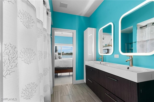 ensuite bathroom with double vanity, visible vents, a sink, and ensuite bathroom