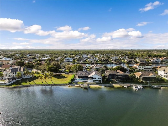 bird's eye view featuring a water view and a residential view