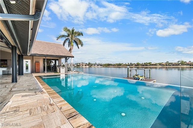 view of swimming pool with an infinity pool, a patio, a dock, and a water view