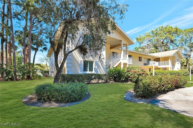 exterior space with stucco siding and a lawn