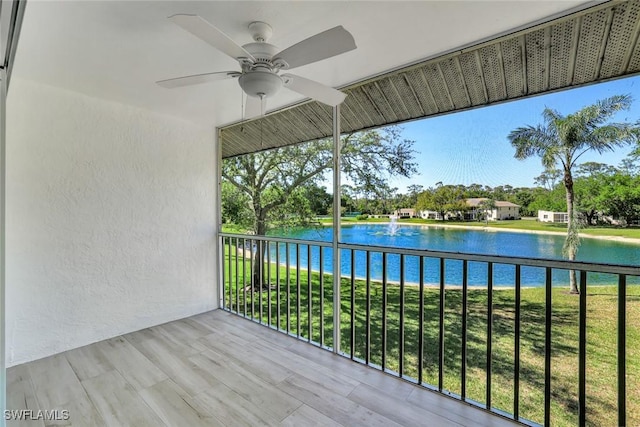 balcony with a water view and ceiling fan