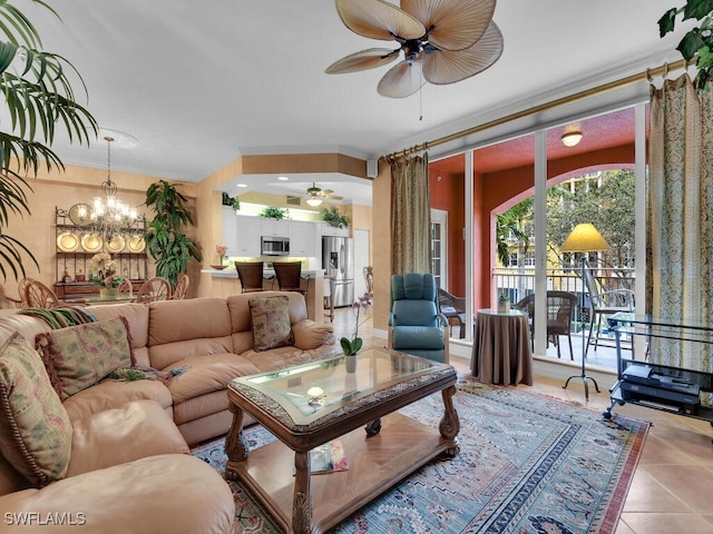 living area with ceiling fan with notable chandelier, crown molding, and tile patterned floors