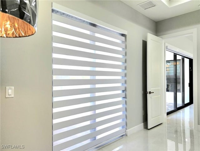 interior space featuring a wealth of natural light, visible vents, and baseboards