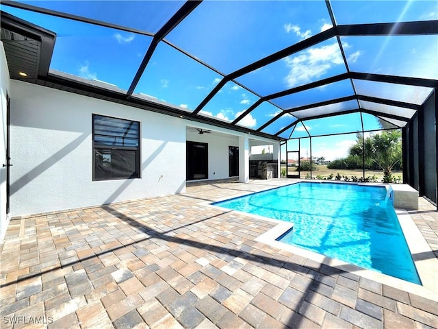 pool featuring a lanai, a ceiling fan, and a patio