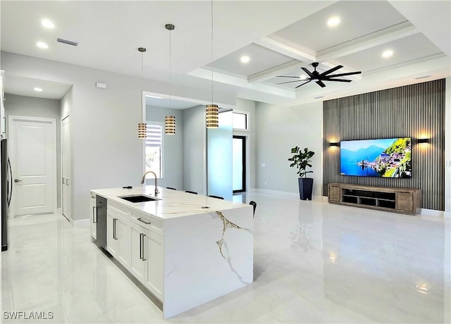 kitchen featuring marble finish floor, open floor plan, a sink, light stone countertops, and coffered ceiling