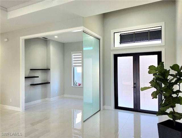 interior space featuring recessed lighting, french doors, and baseboards