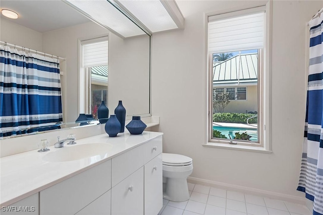 full bathroom with curtained shower, baseboards, toilet, tile patterned floors, and vanity