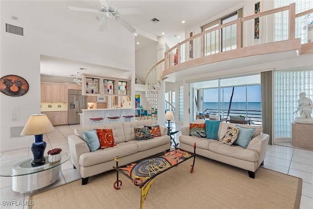 living area featuring ceiling fan, visible vents, and light tile patterned flooring