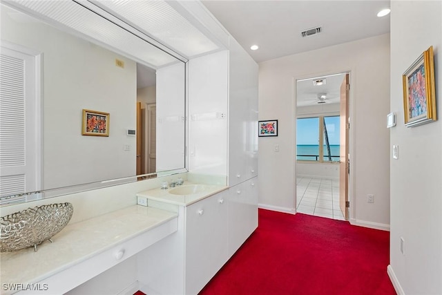 bathroom featuring vanity, recessed lighting, visible vents, and baseboards