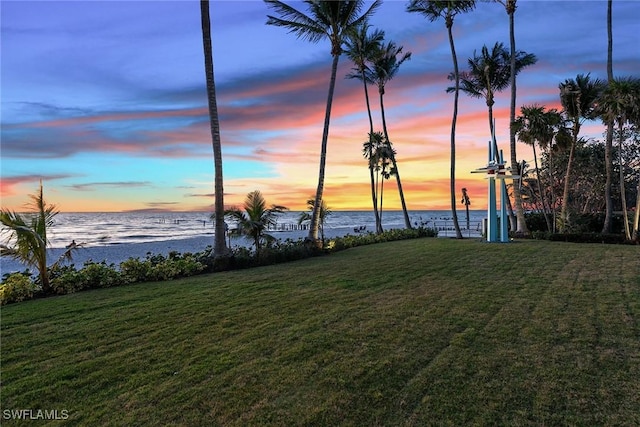 yard at dusk with a water view