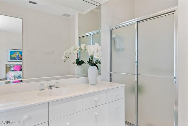 ensuite bathroom featuring a shower with door, connected bathroom, visible vents, and vanity