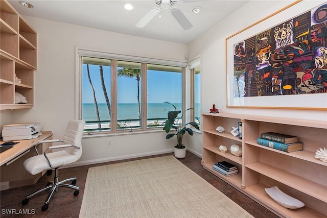 office space with baseboards, a wealth of natural light, and ceiling fan