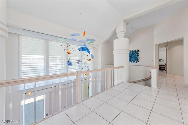 hall featuring tile patterned floors and high vaulted ceiling