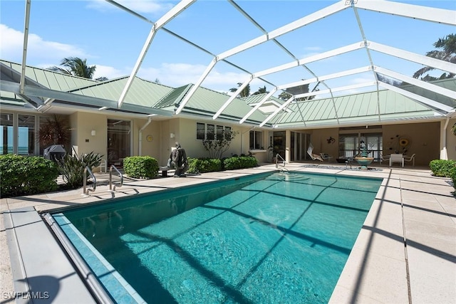 pool with glass enclosure and a patio