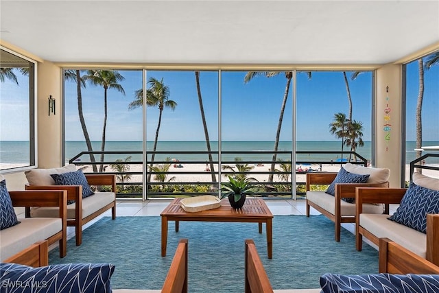 sunroom featuring a healthy amount of sunlight and a water view