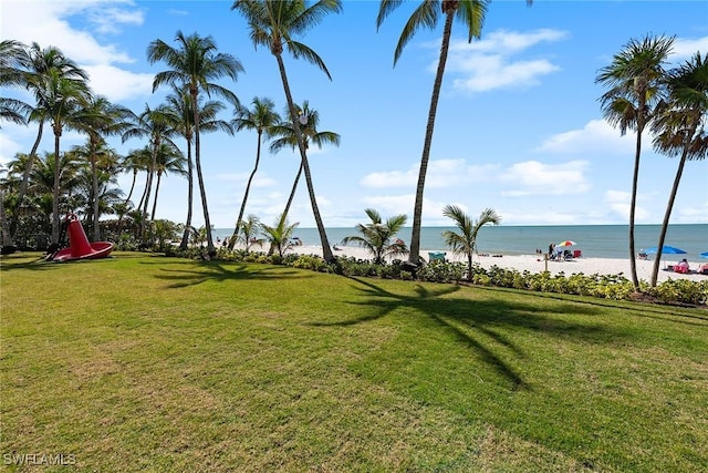 exterior space with a water view and a view of the beach