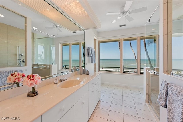 30 3rd Ave S, Naples, FL 34102 - full bathroom featuring a ceiling fan, tiled shower, vanity, baseboards, and a water view