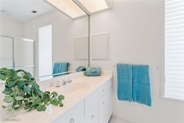 30 3rd Ave S, Naples, FL 34102 - bathroom with a shower stall, vanity, and tile patterned floors