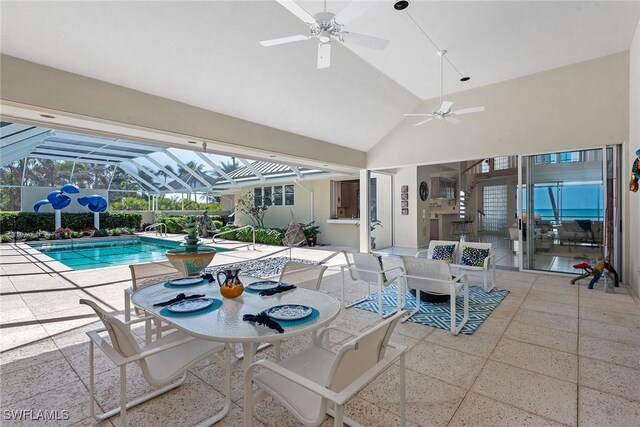 30 3rd Ave S, Naples, FL 34102 - outdoor pool featuring a ceiling fan, a patio area, outdoor dining space, and glass enclosure